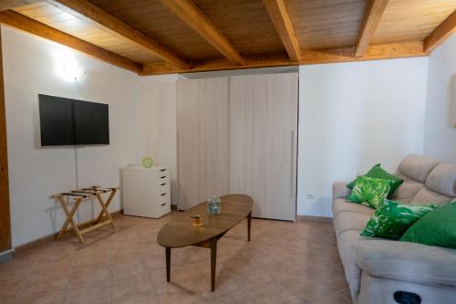 a living room with a couch and a tv at La Casa di Teo Sorrento Coast in Sant'Agnello