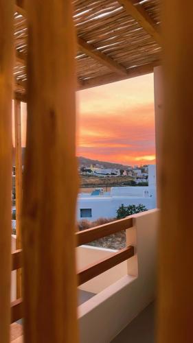 a view of a sunset from a balcony of a building at Mykonos Dot Suites in Ano Mera