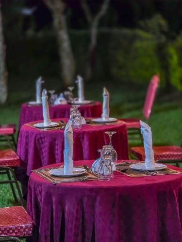 a group of purple tables with candles on them at Juniper Park Resort in Nyahururu