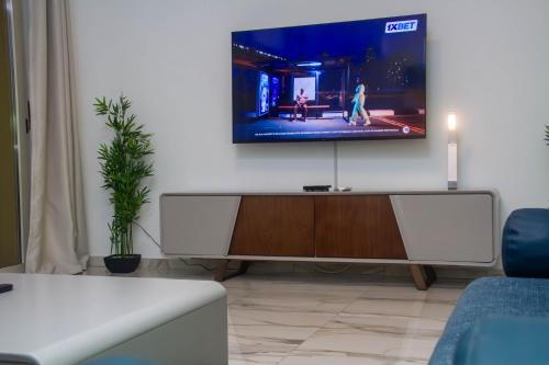 a living room with a flat screen tv on a wall at Appartement Ornella in Azuretti