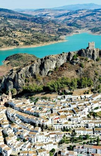 an aerial view of a village on a hill next to a body of water at La BODEGA DE ROSARIO in Algodonales