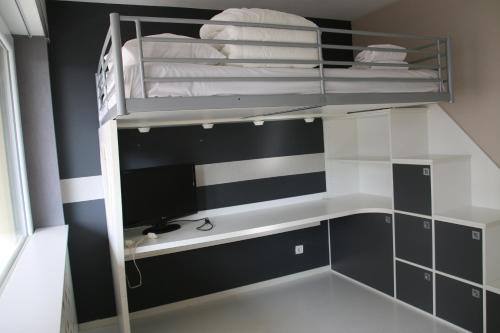 a bunk bed with a desk and a computer in a room at Le petit Robinson - Metz - 4 people in La Celle-sous-Gouzon