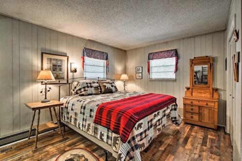 a bedroom with a bed and a wooden floor at Modern Rustic Cabin - Cozy Forest Escape in Gatlinburg