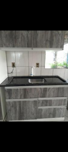 a kitchen counter with a sink and a window at Casa Bela Vista in Blumenau