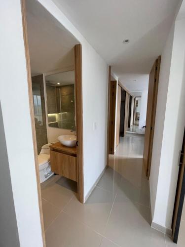 a bathroom with a sink and a mirror at Apartamento Sur de Cali in Cali