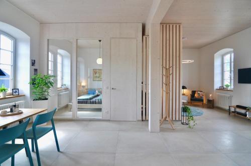 a living room with a door leading to a bedroom at Alte Schule - Modern Wohnen in historischen Altbau in Baustert