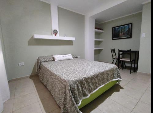a bedroom with a bed and a table and chairs at San Clemente Aventura in San Clemente del Tuyú