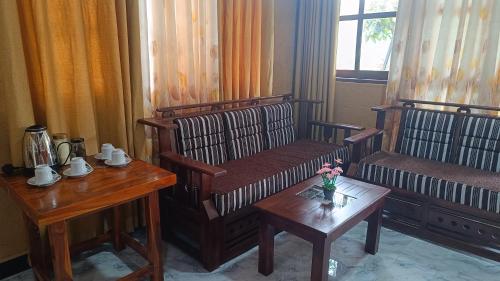 a living room with a couch and a table with a table sidx sidx at Forest Rawana homestay Ella in Ella