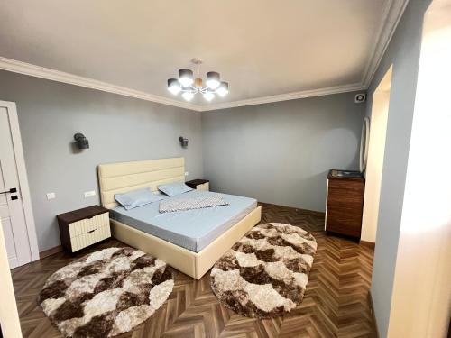 a bedroom with a bed and a rug at Apartment lux in Samarkand