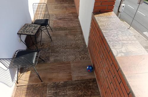 a staircase with two chairs and wooden flooring at Chill family lux Svilajnac in Svilajnac