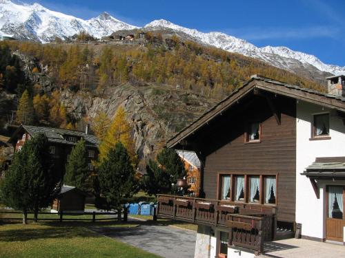 a building with a mountain in the background at Chalet Sunstar in Saas-Grund