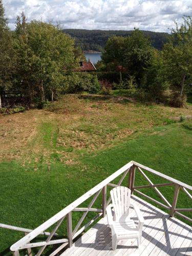 a white chair sitting on top of a deck at Orust East Coast Villa in Stillingsön