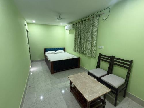 a room with a bed and a chair and a table at Riddhi kitchen in Silao