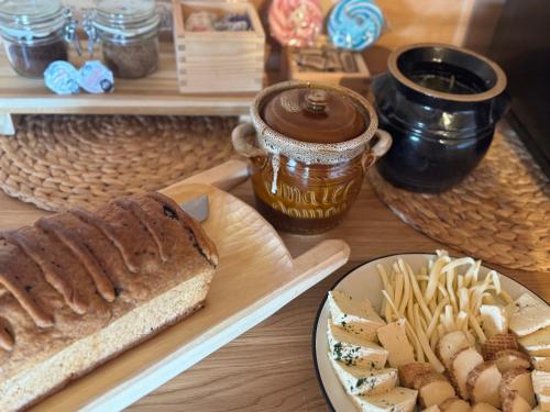 a table with a loaf of bread and a plate of pasta at Mecenasówka Noclegi in Zawoja