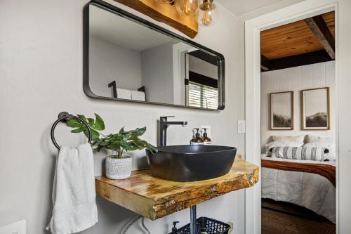 a bathroom with a sink and a mirror at TreeLicious Jacuzzi Cozy Chalet close to Slopes in Big Bear Lake
