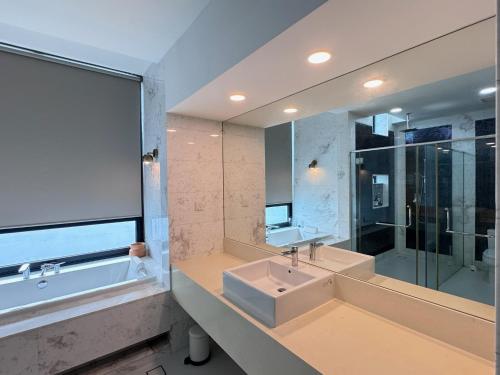 a bathroom with a sink and a large mirror at Malibu 2BR Villa - Private Pool Langkawi in Pulau Tepur