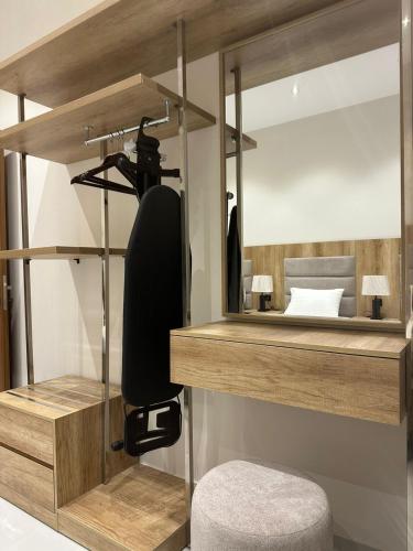 a bedroom with a mirror and a chair and a bed at W Hotel Apartment in Taif