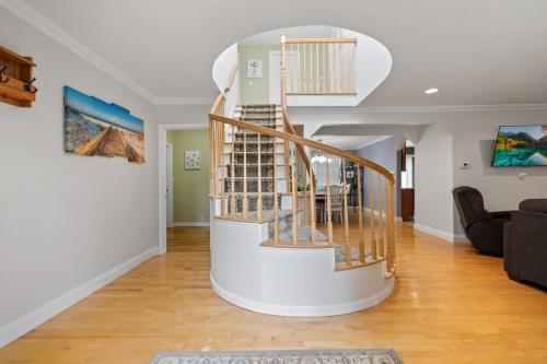 a spiral staircase in a living room with a couch at Secluded Sanctuary in Nature in Monroe