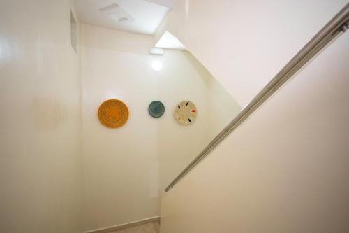 a hallway with two clocks on the wall at Dar Diafa Anza in Agadir