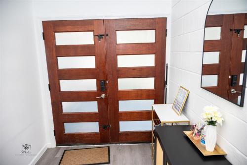 a pair of wooden doors in a hallway at Serenity Suite in Jacksonville