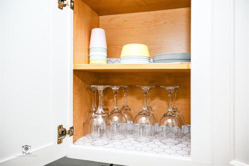 a cabinet filled with wine glasses and plates at Serenity Suite in Jacksonville
