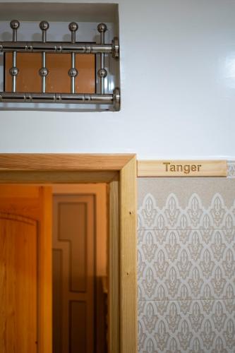 a sign that reads transfer above a door at Dar Diafa Anza in Agadir