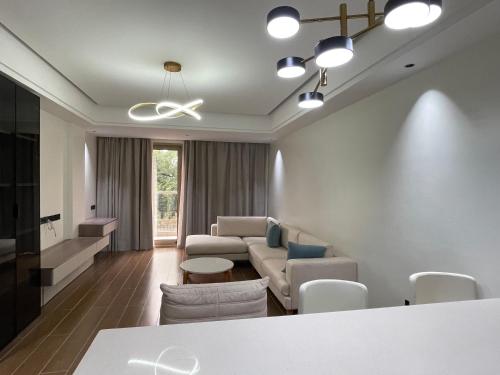 a living room with a couch and a table at Palatial Luxury Hotel and Apartment Juba in Juba