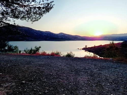 a view of a lake at sunset at Beautiful House in Periana, Ideal for hikers in Periana