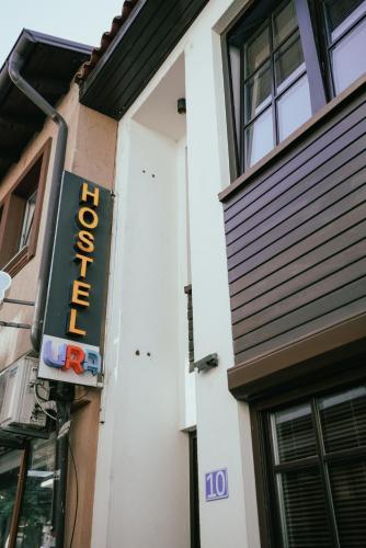 a hotel sign on the side of a building at Ura Hostel in Prizren