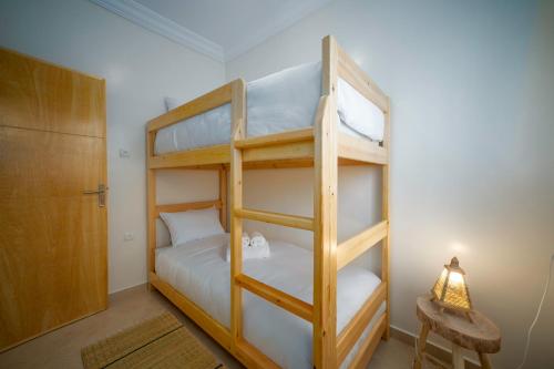 a bedroom with two bunk beds and a lamp at Dar Diafa Anza in Agadir