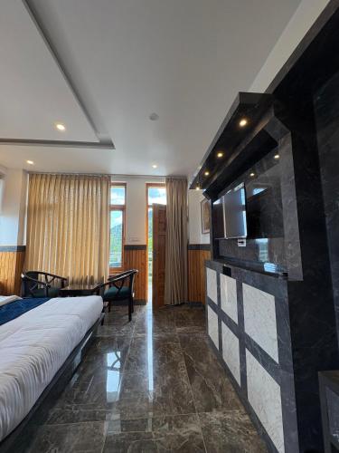 a hotel room with a bed and a television at Tara Van in Dharamshala