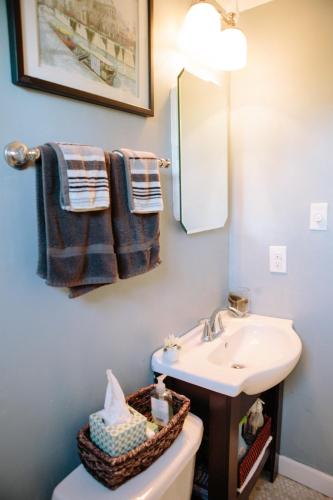 a bathroom with a sink and a mirror and towels at Modern Apartment - Cameron Village in Raleigh