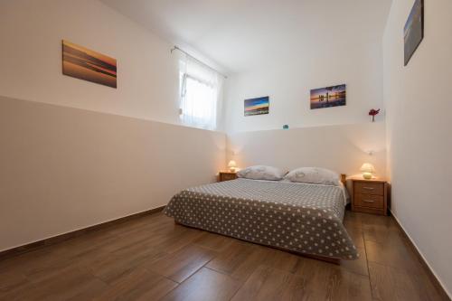 a bedroom with a bed and two night stands at Apartment Rita in Preko