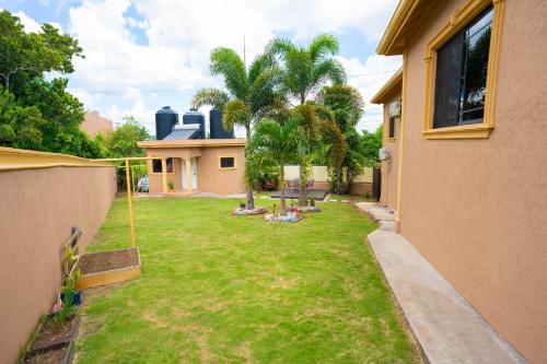 a backyard with a lawn with a swing at Dw apartments with garage and hot tub in Mandeville