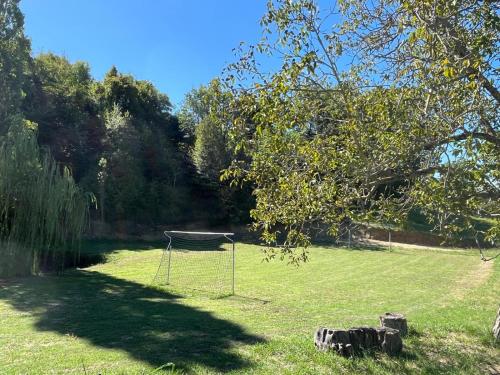 a net in the middle of a grass field at La Casa di Farfa - Lovely Home in Sabina in Bocchignano