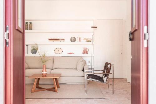 a living room with a couch and a table at Dona Ana House in Tavira