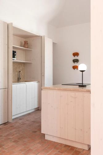 a kitchen with white cabinets and a counter top at Dona Ana House in Tavira