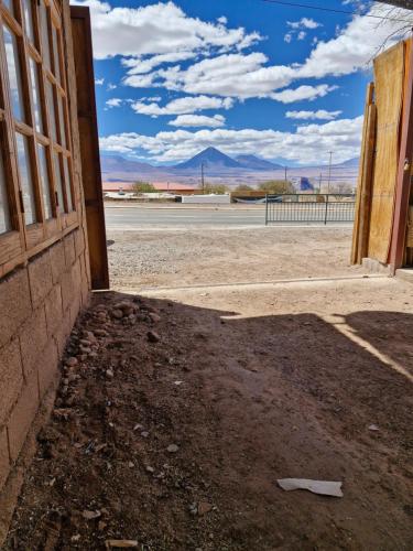 an open door to a building with a view of the desert at hostal casa talitha in San Pedro de Atacama
