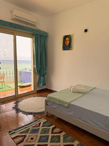 a bedroom with a bed and a view of the ocean at Sun and sea2 in Dahab