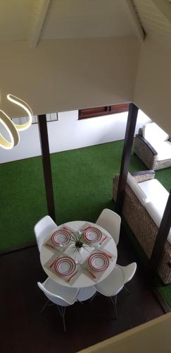a dining room with a table and white chairs at Siberie Apartments Curaçao in Willibrordus