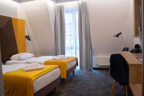 a hotel room with two beds and a window at Villa Ozone in Sopot