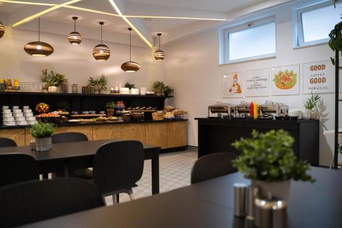 a restaurant with tables and chairs and a counter at Villa Ozone in Sopot