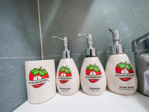 a group of four shampoo bottles sitting on a bathroom counter at Strawberry House , Tour & Motorbikes Rentel in Ha Giang