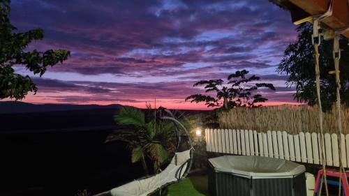 a view of the sunset from the balcony of a house at וילה במושב בנוף מושלם כל השנה in Moledet