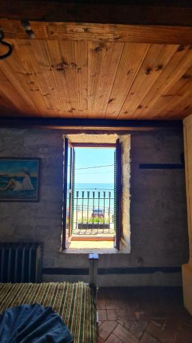 a bedroom with a window with a view of the ocean at Villa Bellavista in Kavarna