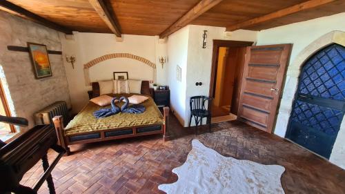 a bedroom with a bed and a wooden ceiling at Villa Bellavista in Kavarna