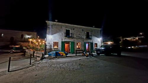 a building at night with cars parked in front of it at Villa Bellavista in Kavarna