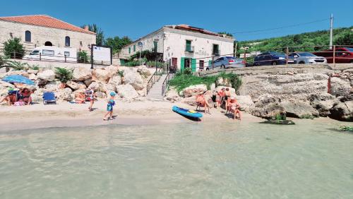 a group of people on a beach near the water at Villa Bellavista in Kavarna