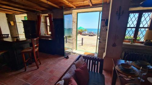 a room with a table and a view of the ocean at Villa Bellavista in Kavarna