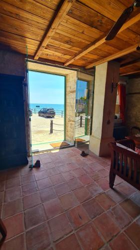 a patio with a view of the beach through a glass door at Villa Bellavista in Kavarna